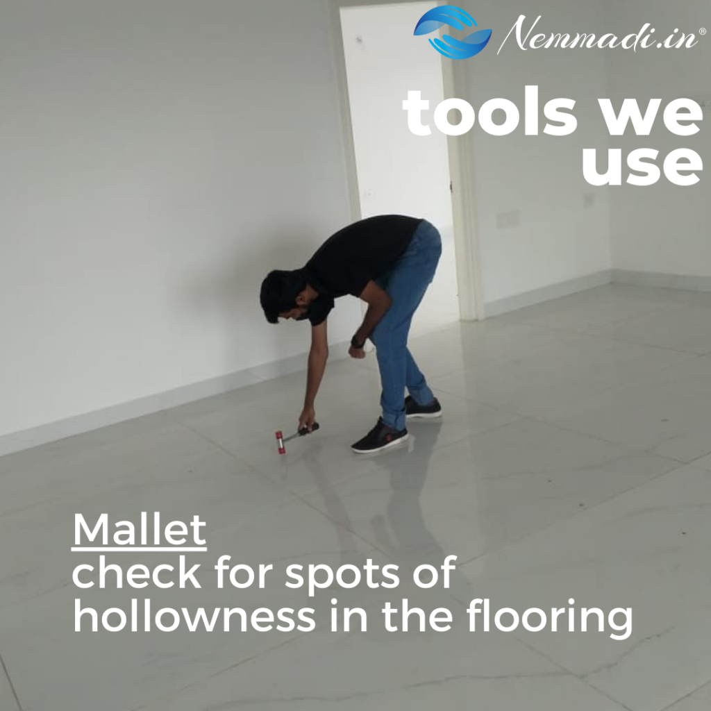 Nemmadi tools we use card: an inspector tapping the floor with a mallet to find hollow spots