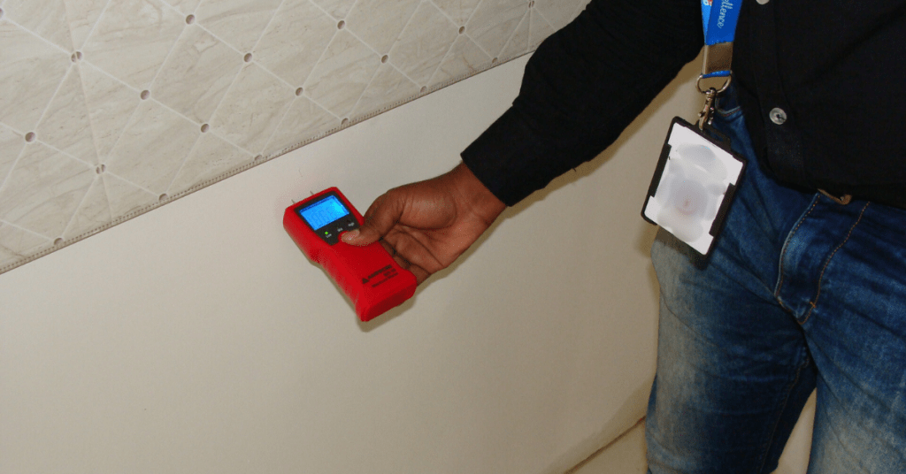 Checking dampness in walls using moisture meter