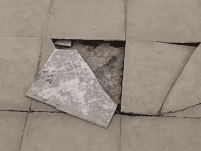 Hollow floor detection with specialized tools showing red marking on tile